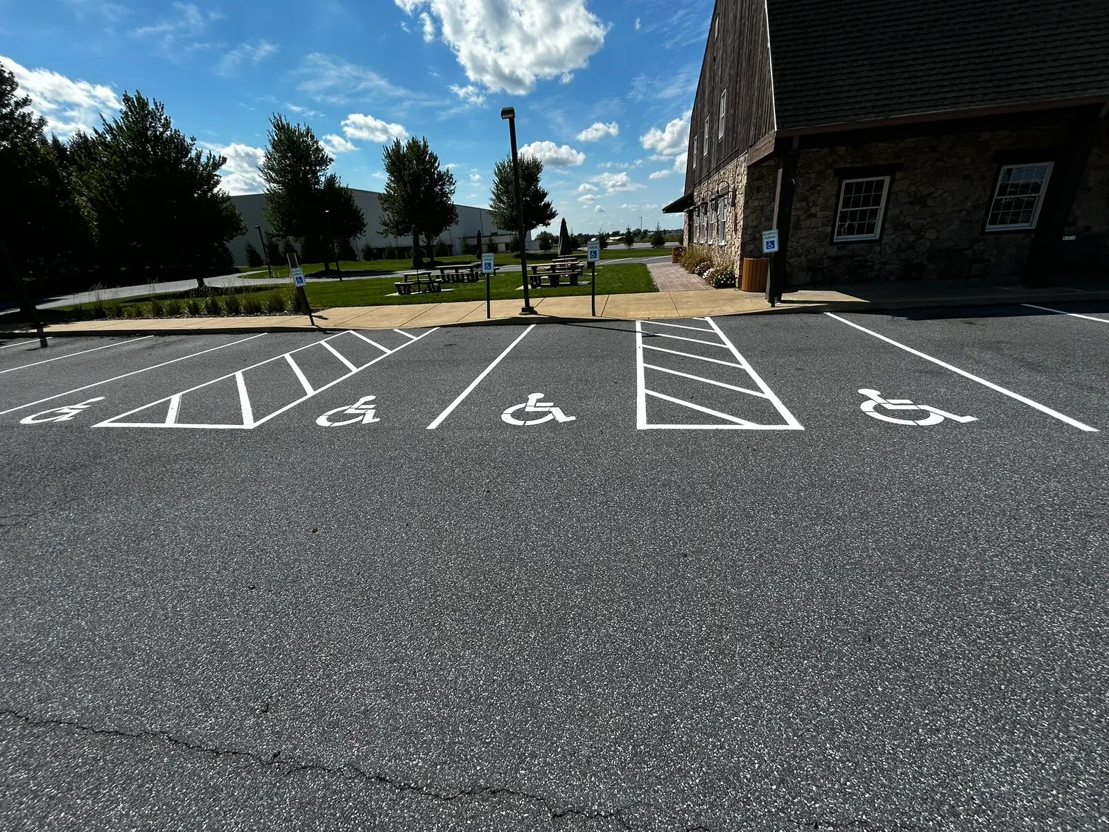 ADA stalls with blue symbols and hatched aisles in a restriped lot
