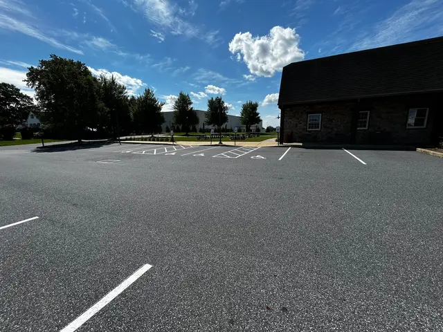Wide view of a lot with new white stalls and ADA spaces