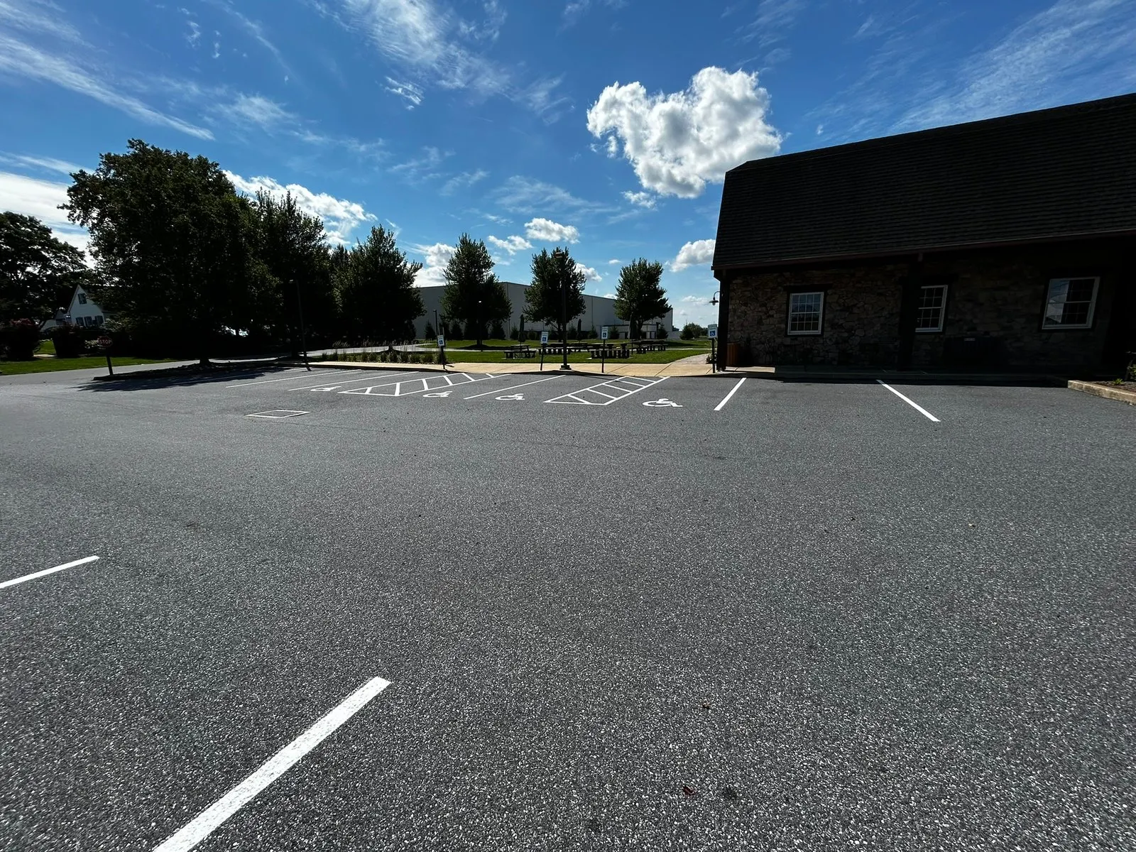 Wide view of a lot with new white stalls and ADA spaces