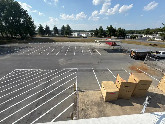 Commercial lot re-striped with white stalls and hatching, seen from above