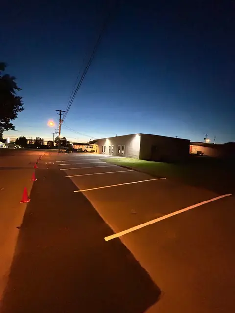 Fresh white stall lines on blacktop at dusk