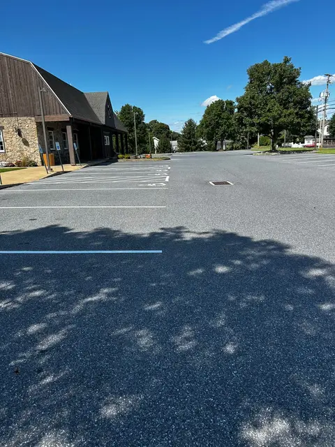Restriped lot with fresh white lines and long afternoon shadows
