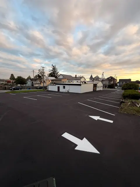 Sealed lot with new white directional arrows and stall lines
