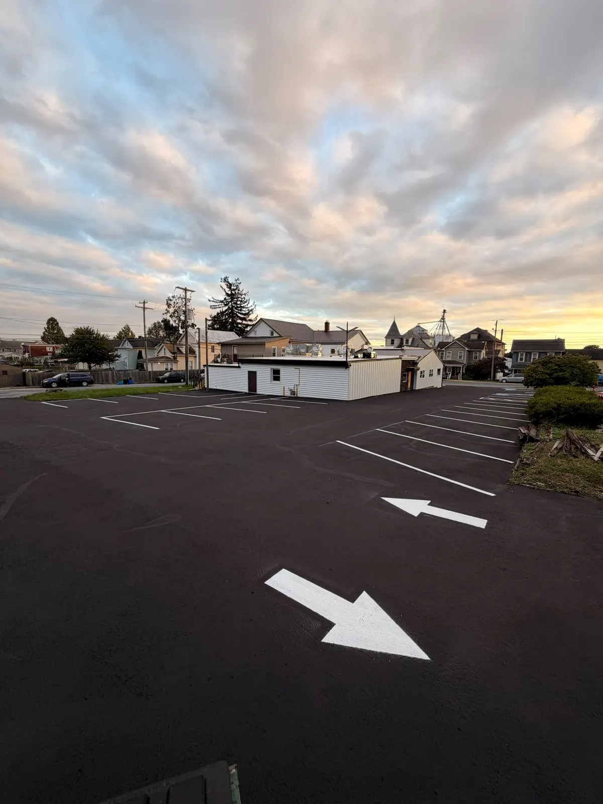 Sealed lot with new white directional arrows and stall lines