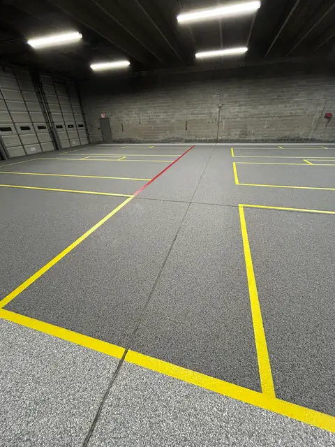 Yellow floor layout lines in a lit warehouse bay