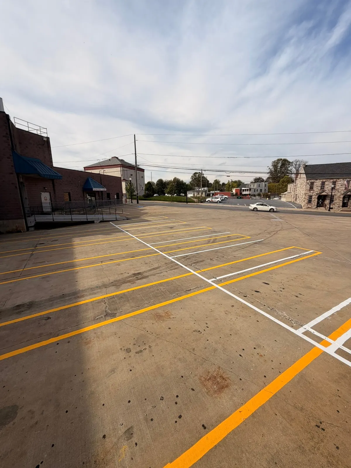 Yellow and orange line work across a wide commercial lot