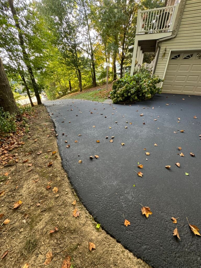 Freshly paved driveway with fallen leaves