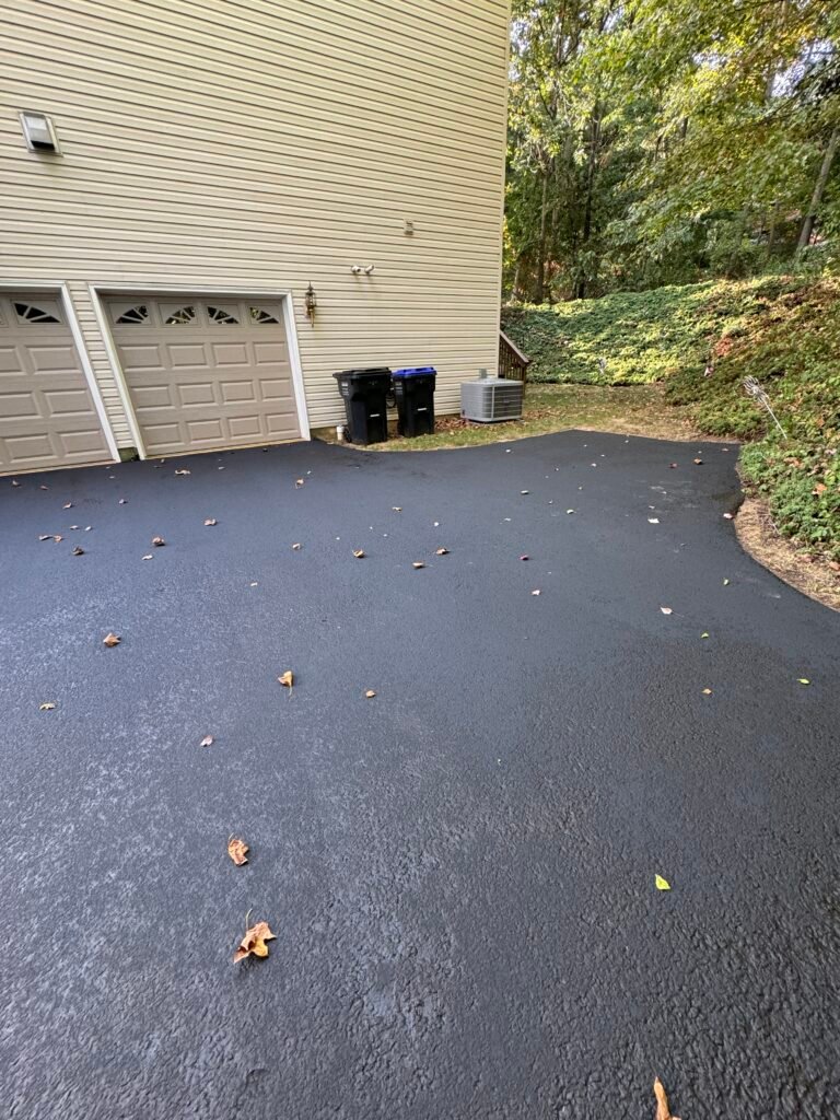 Freshly paved driveway with garbage bins