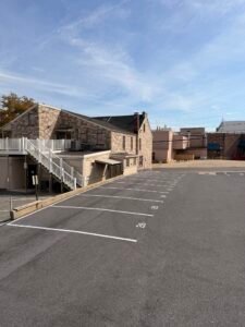 Stone building beside empty parking lot